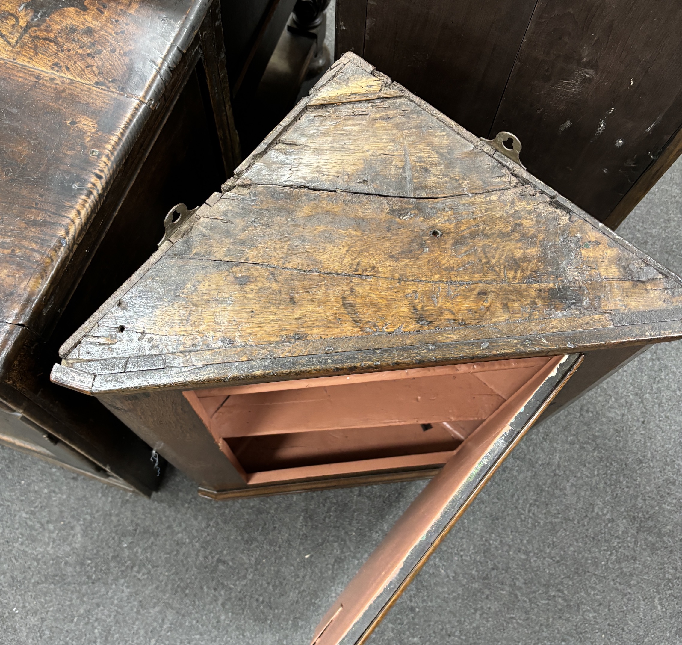 A late 18th century oak hanging corner cupboard, width 55cm, depth 30cm, height 80cm
